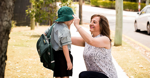 Lady helping child with walking to school