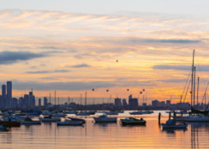 Harbour with Melbourne city in background at sunset near Waterline Place community by AVJennings located in Williamstown, VIC 3016. Townhouses for sale in Williamstown. 