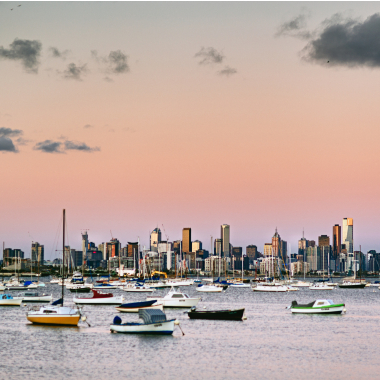 View of the Melbourne CBD at dusk from the Williamstown foreshore. Local area photography Apartments for sale at Waterline Place by AVJennings.